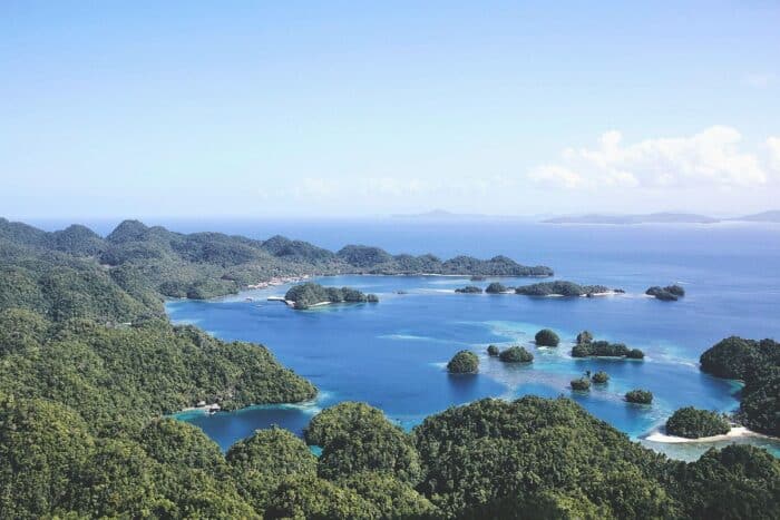 Scenic aerial view of Nay Palad Hideaway on Siargao Island, with beachfront villas set between white sand shores, turquoise waters, and lush tropical greenery.