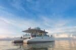 Catamaran 72 yacht for rent in Cebu, elegantly cruising through clear blue waters with a spacious deck and modern design, perfect for a premium yacht charter experience.