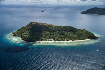 Aerial view of Ariara Private Island in Palawan, a luxury private island for rent with white sand beaches, turquoise waters, and exclusive beachfront villas.