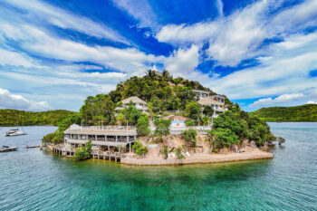 Aerial view of Pearl Bay Villas in Palawan near WW2 shipwrecks, showcasing the best villas to stay in Palawan with beachfront views and clear waters.