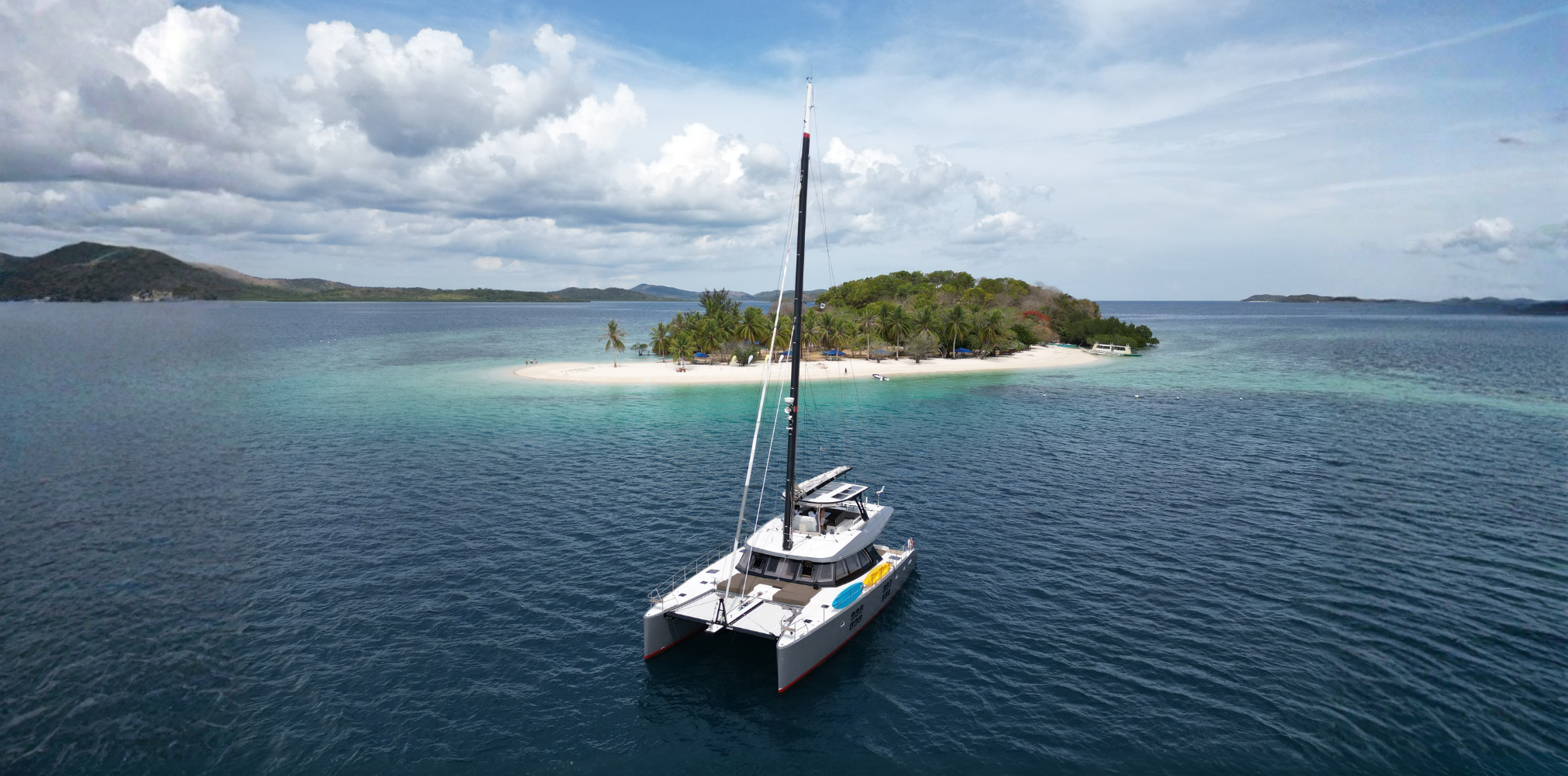 Sunreef 60 cruising through Pass Island, best catamarans for charter in Palawan.